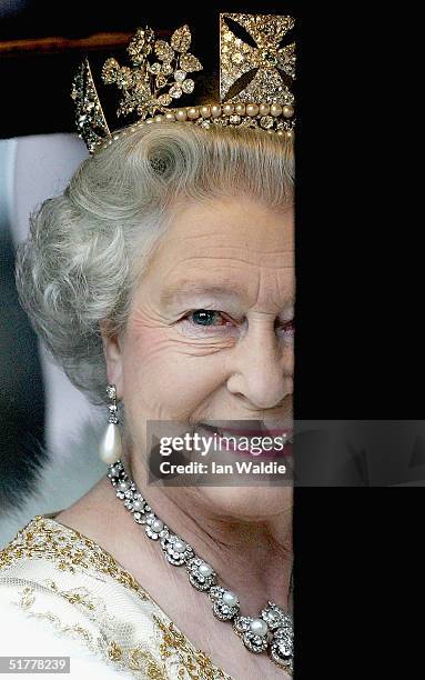 Queen Elizabeth II looks out of the window of her carriage as ahe arrives for the state opening of Parliament November 23, 2004 in London. In her...