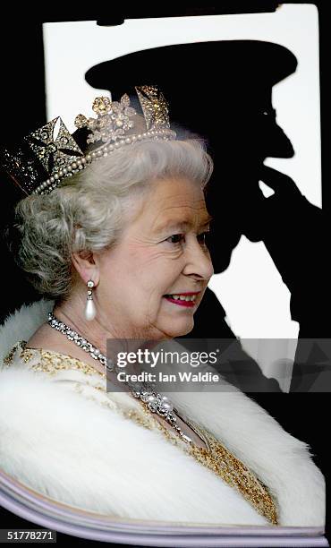 Queen Elizabeth II looks out of the window of her carriage as ahe arrives for the state opening of Parliament November 23, 2004 in London. In her...