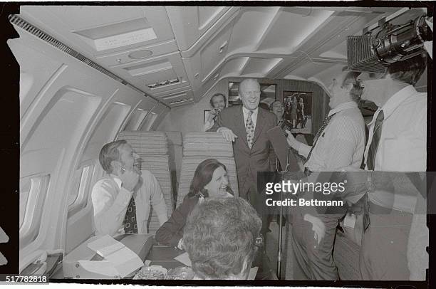President Ford shares a hearty laugh with newsmen aboard Air Force One en route home from Martinique here, and his summit talks with French President...