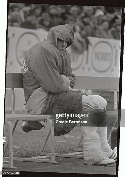 New England Patriot's star offensive guard John Hannah sits glumly on bench, as he watches his team being defeated by the New York Jets, with 21-26...