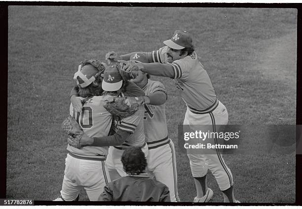Members of the Oakland A's gather around reliever Rolle Fingers, after Fingers saved the game to allow Oakland to defeat the Baltimore Orioles 2-1,...