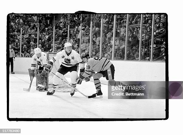 Clarence Campbell Conference All-Star Wayne Gretzky is turned around by Prince of Wales Conference All-Star Jim Schoenfeld behind the goal during the...