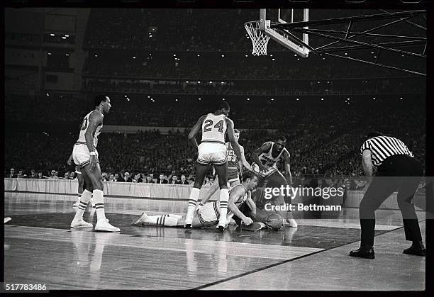 Houston's Ken Spain and UCLA's Lew Alcindor dive to the floor after a loose ball in the second half of play here. Looking on are Houston's Don Chaney...