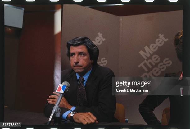 Tom Hayden, political activist from California, seen here sitting before a microphone.
