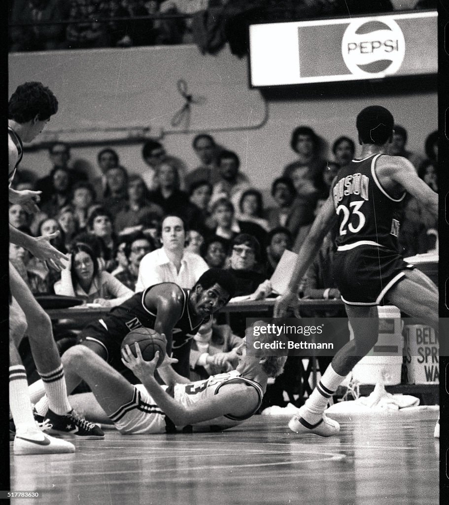 Larry Bird Lying on the Floor During Basketball Action