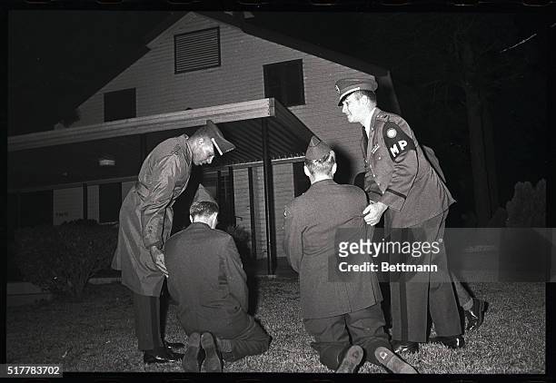 Military Police encourage two soldiers to leave as they kneeled and prayed outside a darkened base chapel here at Fort Jackson. The soldiers along...
