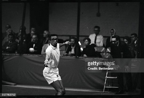 Second seeded Arthur Ashe, of Richmond, Virginia, makes a backhand return during his second round match in the 1968 U.S. National Indoor Tennis...