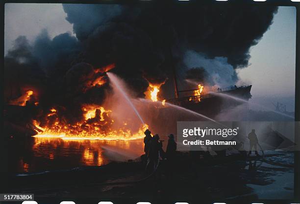 Firemen face a raging inferno as they battle oil tanker fire in La Plata Harbor, 5/6. Three state-owned tankers and oil dock facilities were...
