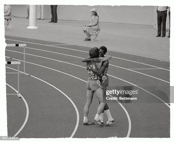 Michael Shine, of Youngsville, Pennsylvania and Edwin Moses, of Atlanta, Georgia, hug each other after winning second and first places, respectively,...