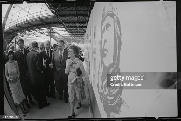 Anne Morrow Lindbergh, widow of Charles Lindbergh, first man to fly across the Atlantic alone, is escorted past a wall of photos commemorating the...