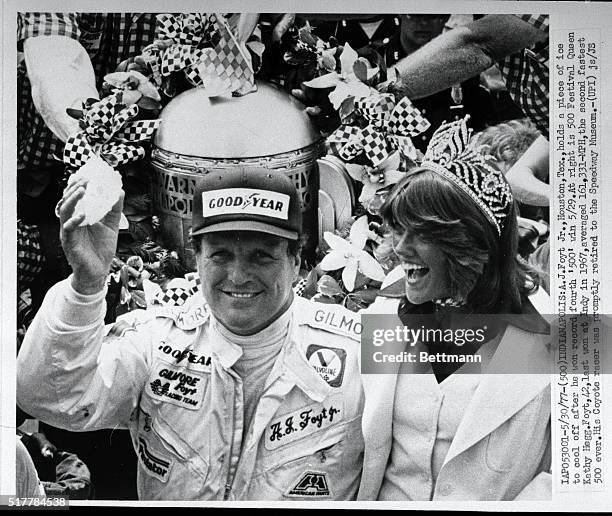 Foyt, Jr., Houston, Texas, holds a piece of ice to cool off after he won his record fourth '500' 5/29. At right is 500 Festival Queen Kelly Hegg....