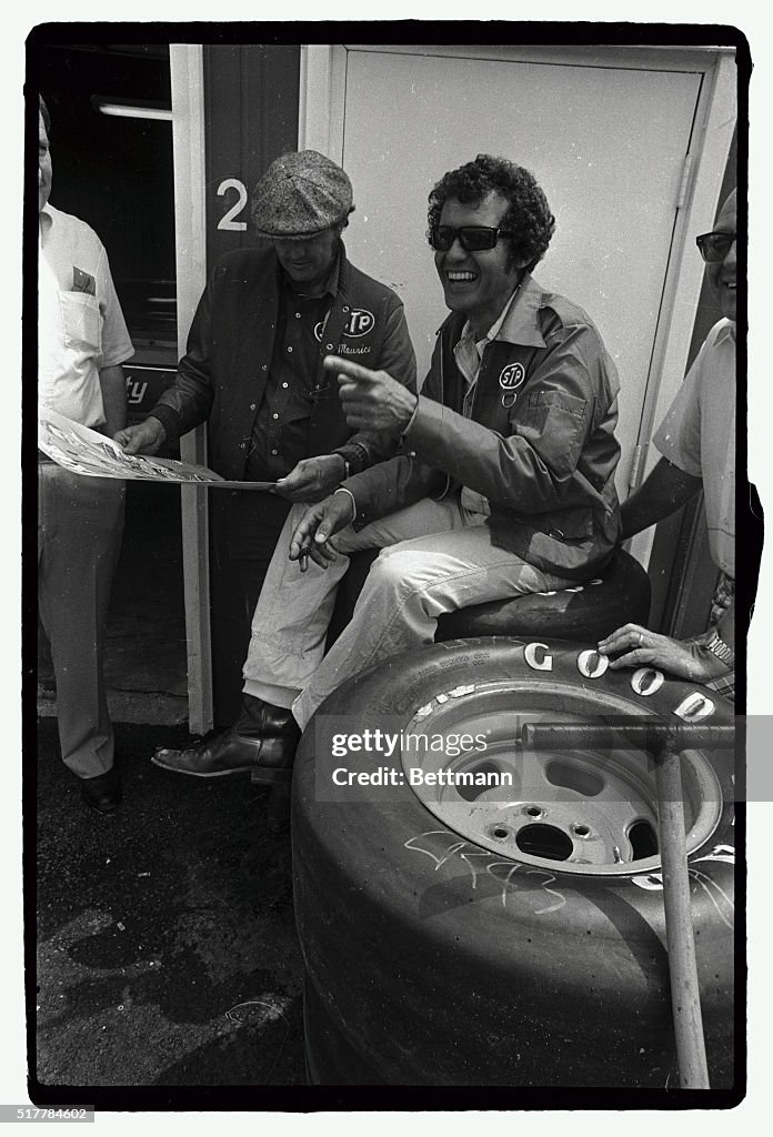 Richard Petty Seated on Tires and Laughing