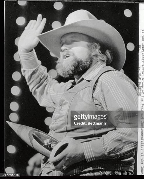 With very little to say, Charlie Daniels waves to the audience as he accepted one of three awards during the Country Music Awards presentations...