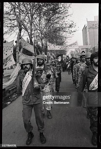 Iranian supporters march past the occupied U.S. Embassy here 12/28, in support of the militant students holding the hostages inside. Islamic militant...