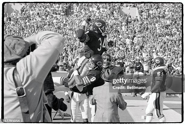 Bears' quarterback Vince Evans holds Walter Payton in the air just after Payton caught a 60-yard touchdown late in the fourth quarter of the game in...