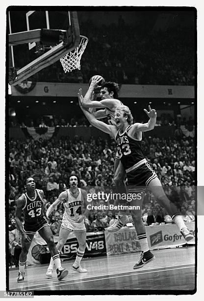 Sixers' Bobby Jones takes a rebound away from the outstretched arms of Boston's Larry Bird during the first quarter of an NBA semi-final game 4/23....