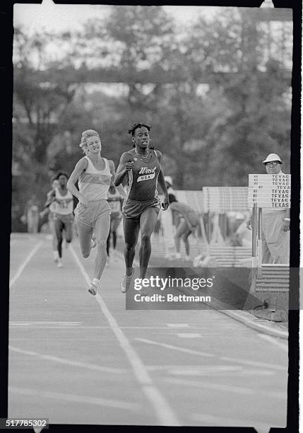 Jackie Joyner of Los Angeles, goes airborne as she pushes toward the finish line edging out Jill Lancaster of Norman, Oklahoma, winning the...