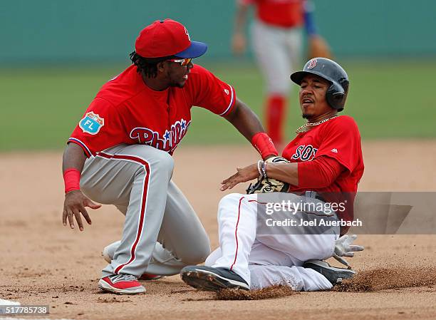 Mookie Betts of the Boston Red Sox is tagged out at third base by Maikel Franco of the Philadelphia Phillies during the fourth inning of a spring...