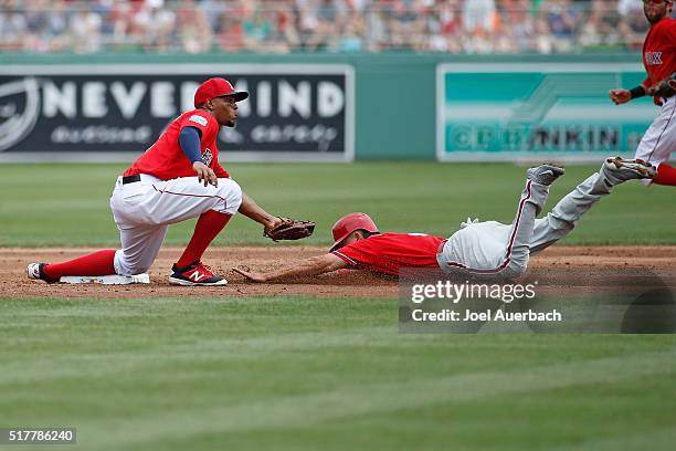 Xander Bogaerts of the Boston Red Sox tags out David Lough of the Philadelphia Phillies attempting to steal during th second inning of a spring...