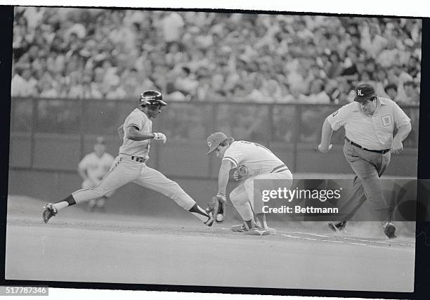 San Francisco's Jose Uribe gets back safely to first base as a pickoff throw starts to squirt out of the mitt of Reds player/manager Pete Rose in the...