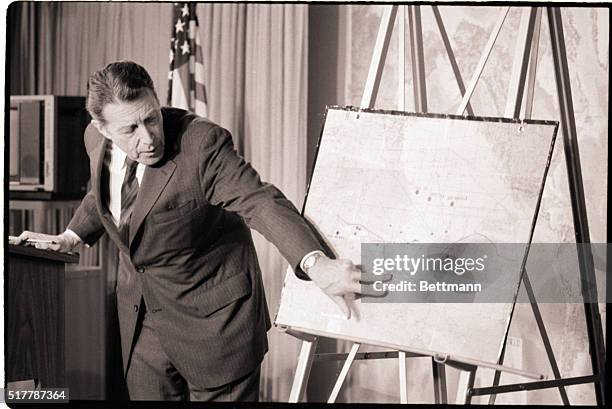 Washington, DC- Defense Secretary Caspar Weinberger points to a map of Libya 3/24 at a Pentagon briefing on Navy warplanes striking a Libyan missile...