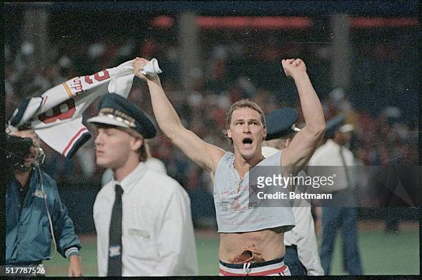 St. Louis: St. Louis Cardinal's Tom Herr wearing his 1982 tee shirt and waving jersey after the Cards defeated the Montreal Expos to win the National...