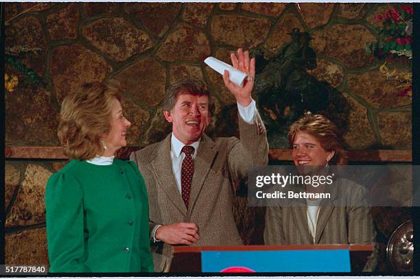 Denver: Flanked by his wife Lee and his daughter Andrea , Sen. Gary Hart, D-Colo., waves to the crowd at an Evergreen Restaurant 1/4 after announcing...