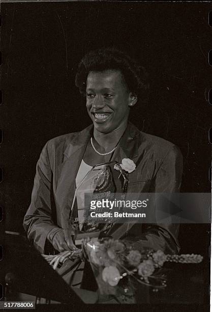 Jackie Joyner-Kersee, of Los Angeles, California holds her trophy after being named 1986 Sportswoman of the Year by the U.S. Olympic Committee at a...
