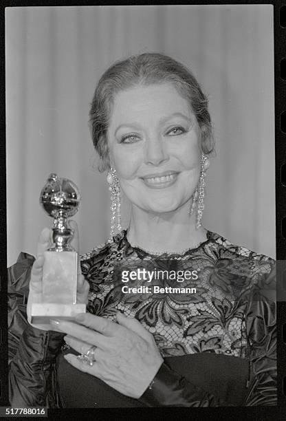 Hollywood: Actress Loretta Young holds up her Golden Globe award that she won for best performance by an actress in a mini-series or a motion picture...