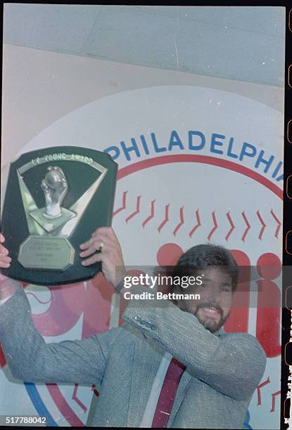 Philadelphia: Philies' relief pitcher, Steve Bedrosian holds his plaque high after being named the 1987 National Cy Young Award winner during a news...