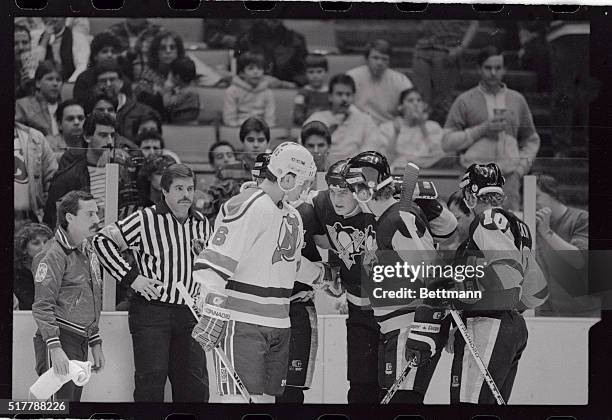 Mario Lemieux of the Pittsburgh Penguins is helped off the ice here by teammate Rod Buskas and Craig Wolanin of the New Jersey Devils after Lemieux...