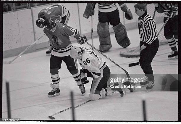 Black Hawk's Doug Wilson tries to steal puck from Penguin's Mario Lemieux as they skate down the ice in game here. Lemieux retained control of the...