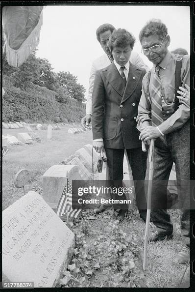 Ahnahkaq Henson Standing by Father's Grave