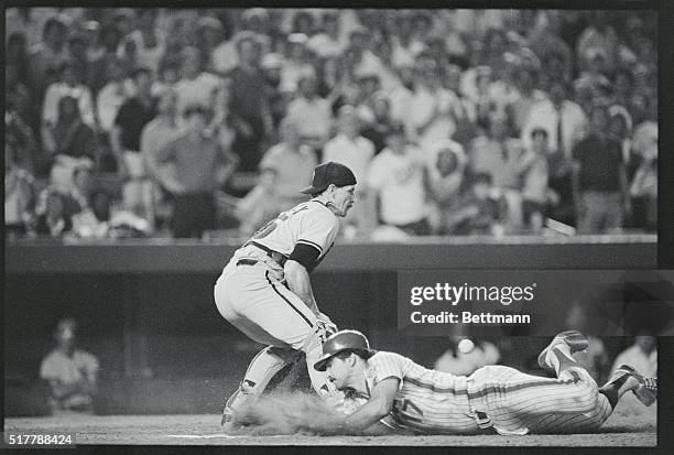 New York: Mets' Keith Hernandez slides home head first beating the ball thrown to Giants' catcher Bob Brenly by left fielder Jeffrey Leonard and...