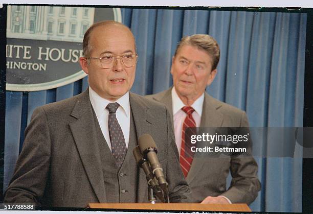 Washington: As national security adviser Robert McFarlane looks on, President Reagan announces the former's resignation from his post at a press...