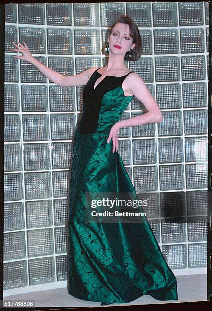 Model wearing green Carolina Herrera design, full length.