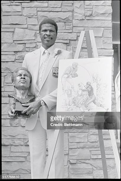Former defensive back for the Houston Oilers and WA Redskins, Ken HOuston, holds the bust in his likeness that will go on display at the Football...