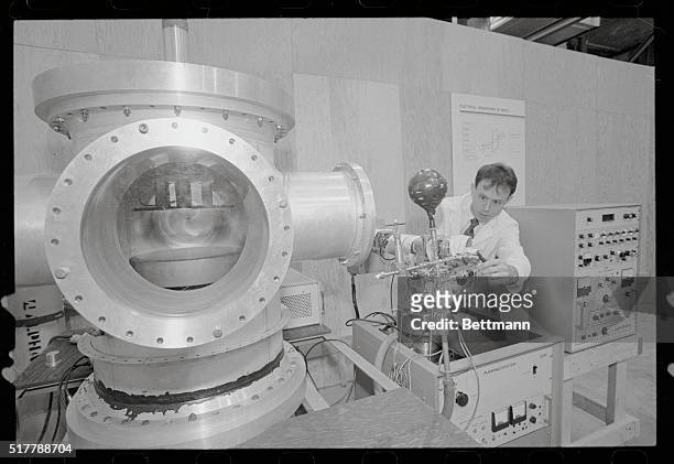Auburn, Alabama: Auburn student Clay Sawyer, of Columbus, Georgia, is shown working with large vacuum chamber used to study electrical breakdown in...