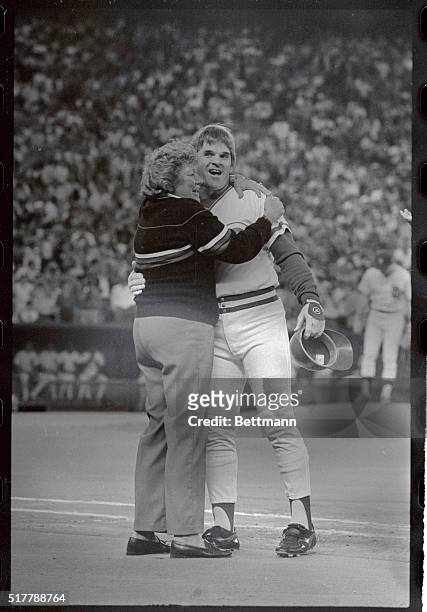 Marge Schott, owner of the Cincinnati Reds, hugs her star player-manager Pete Rose after he hit his record-breaking hit number 4,192 against the...