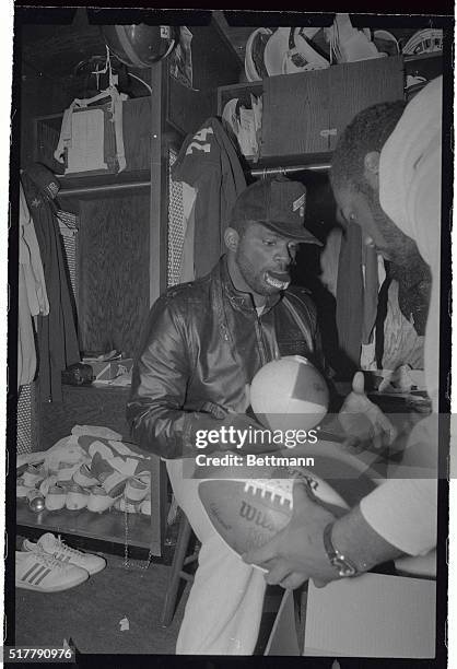 Giant's star linebacker Lawrence Taylor has his hands full, and then some, autographing footballs at practice for the NFC Championship game with the...