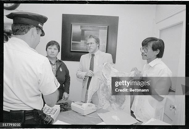 Washington: Charito Planas , Bill Christeson and Dr. Walden Bello of the Philippine Support Group hold a blood stained shirt during a demonstration...