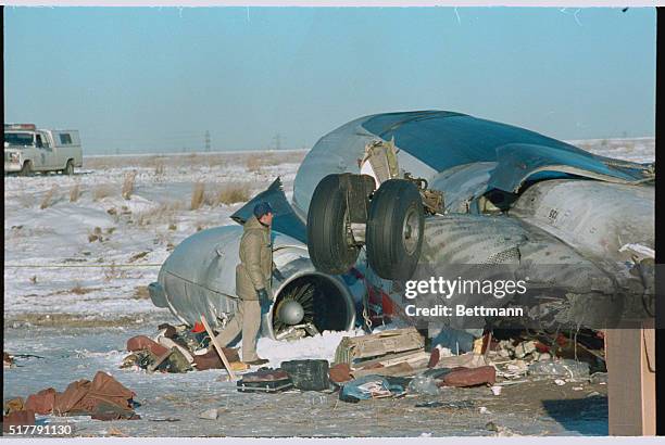 Denver: NTSB spokesman Ted Lopatkiewicz looks over some of the twisted remains, November 16th, of a Continental Airlines DC-9 which crashed while...
