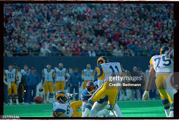 Rams' quarterback Jim Everett is sacked by Giants Lawrence Taylor and fumbles in first quarter 1/7. Ball at left and Rams' Damone Johnson. It was one...