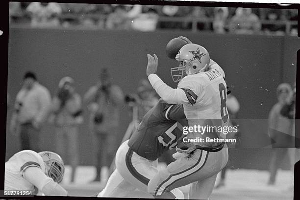 Dallas Cowboy's Troy Aikman eludes the sack by Lawrence Taylor of the New York Giants in the second quarter action at Giants Stadium in this photo....