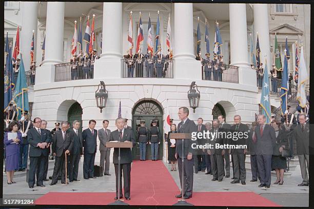Washington: President Bush listens as Japanese Prime Minister Noboru Takeshita makes his departure statement following meetings between the two...
