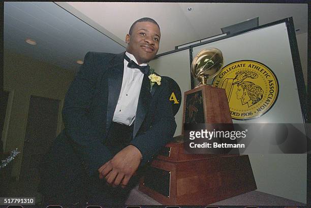 Florence, Ala.: Johnny Bailey, a running back from Texas A&I University poses with the Harlon Hill Trophy presented him here December 11th night. The...
