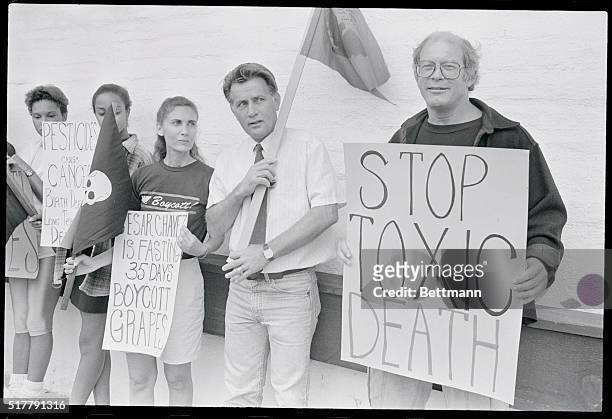 Malibu, California: Actors Max Gail, , and Martin Sheen, , picket outside the Mayfair market in Malibu, California, August 19, along with other...