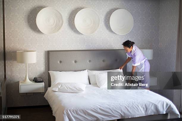 chambermaid making bed in hotel room - arranging pillow stock pictures, royalty-free photos & images