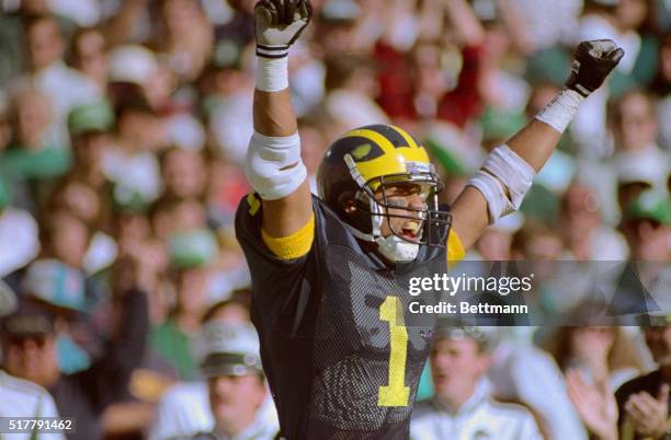 Michigan's Derrick Alexander wearing his number 1, the same number as his team's national ranking, celebrates after scoring a touchdown in the 1st...
