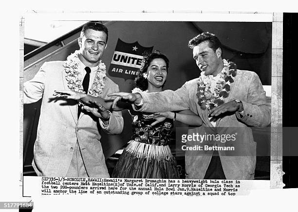 Otto Graham , Cleveland Browns' star quarterback, and Elroy Hirsch, outstanding end of the Los Angeles Rams, get a pretty welcome to Hawaii from...